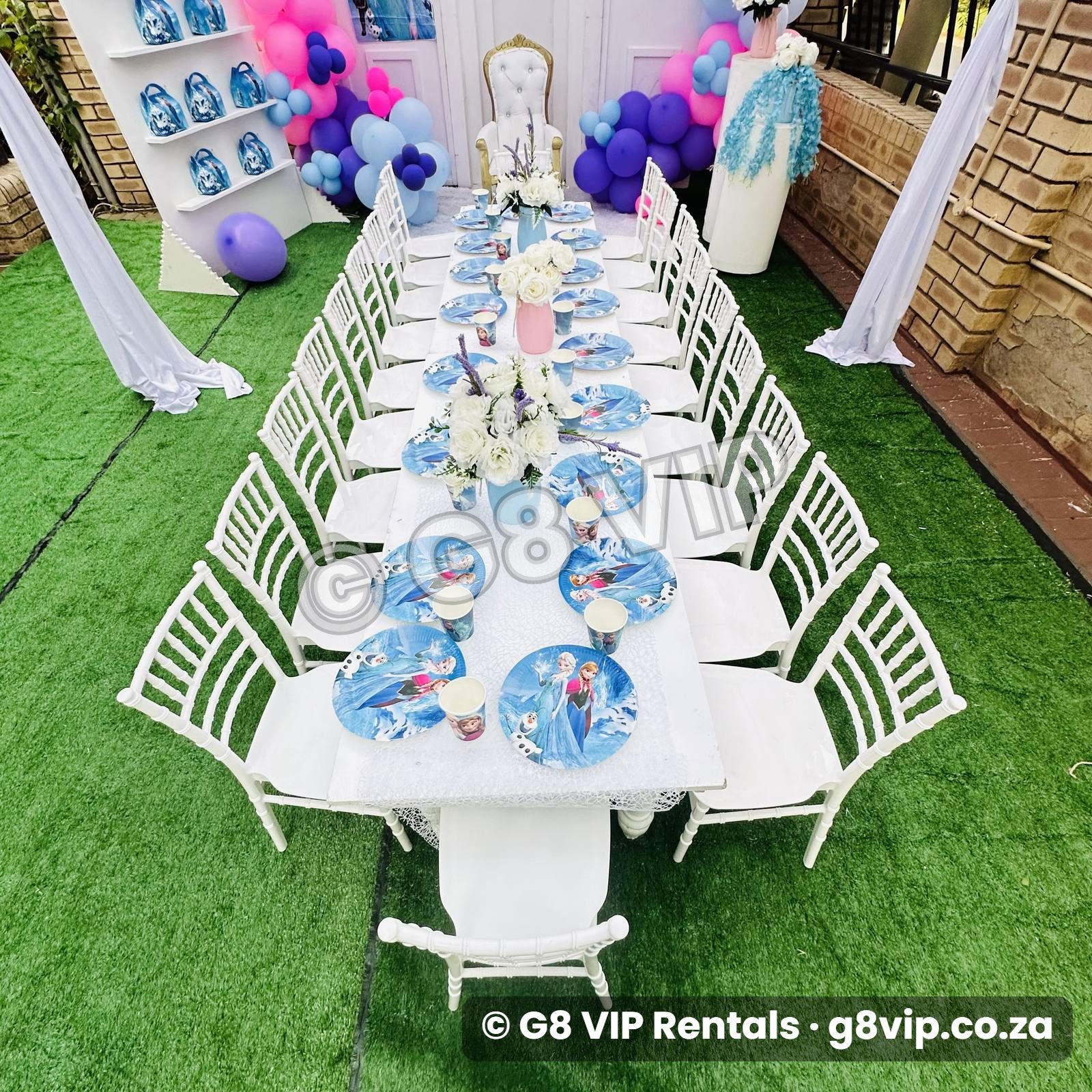 White decor range with balloon arch, white chiavari chairs and elegant table setting
